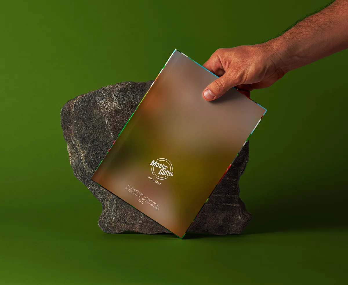 A hand holding the Master Coffee catalog